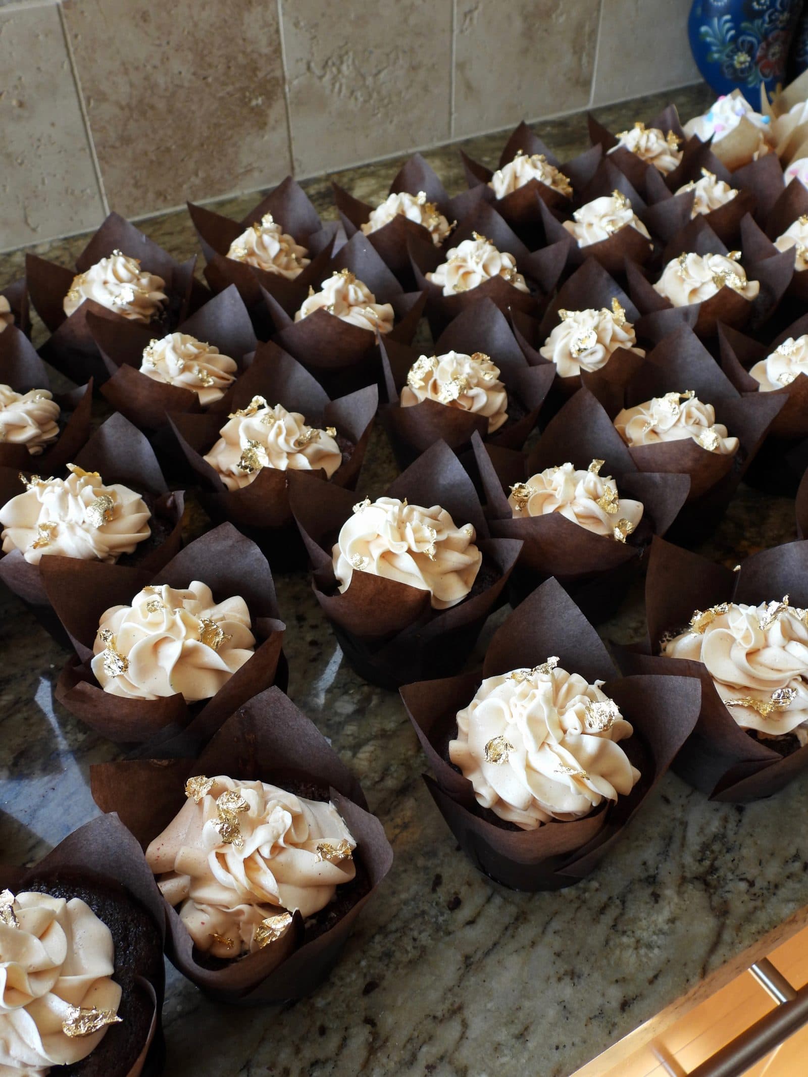 Dark chocolate cupcakes with salted caramel buttercream and gold leaf